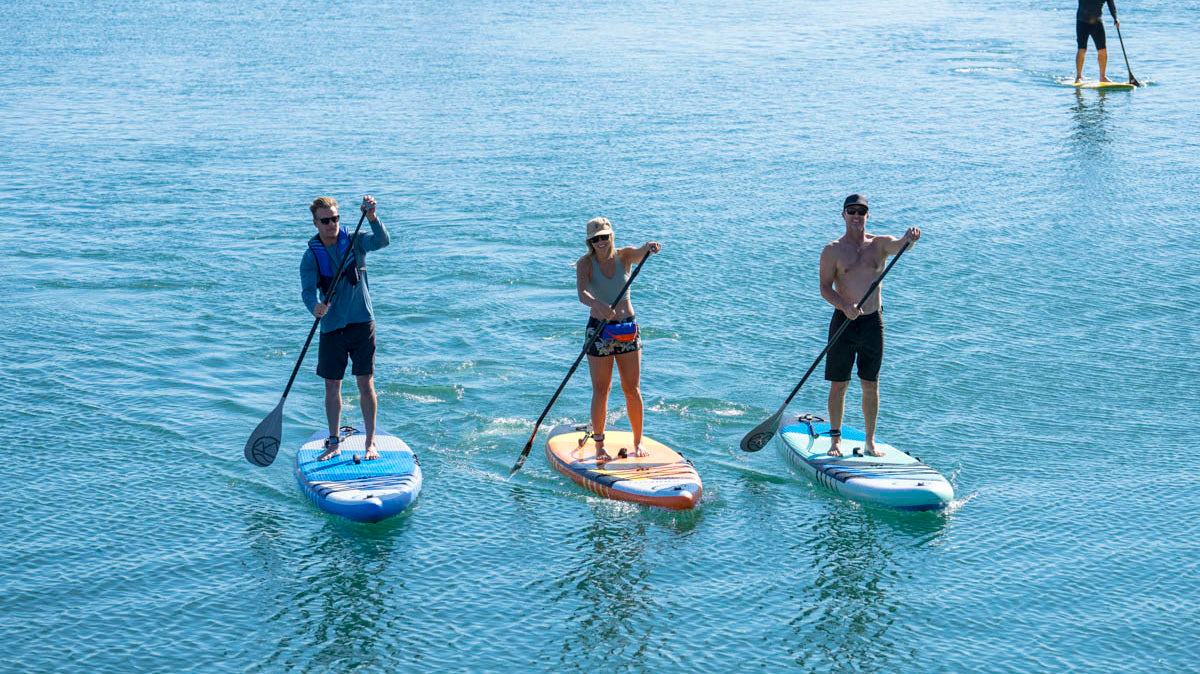 People are paddle boarding with Jimmy Styks inflatable SUPs
