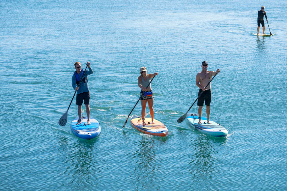 People are paddle boarding with Jimmy Styks inflatable SUPs