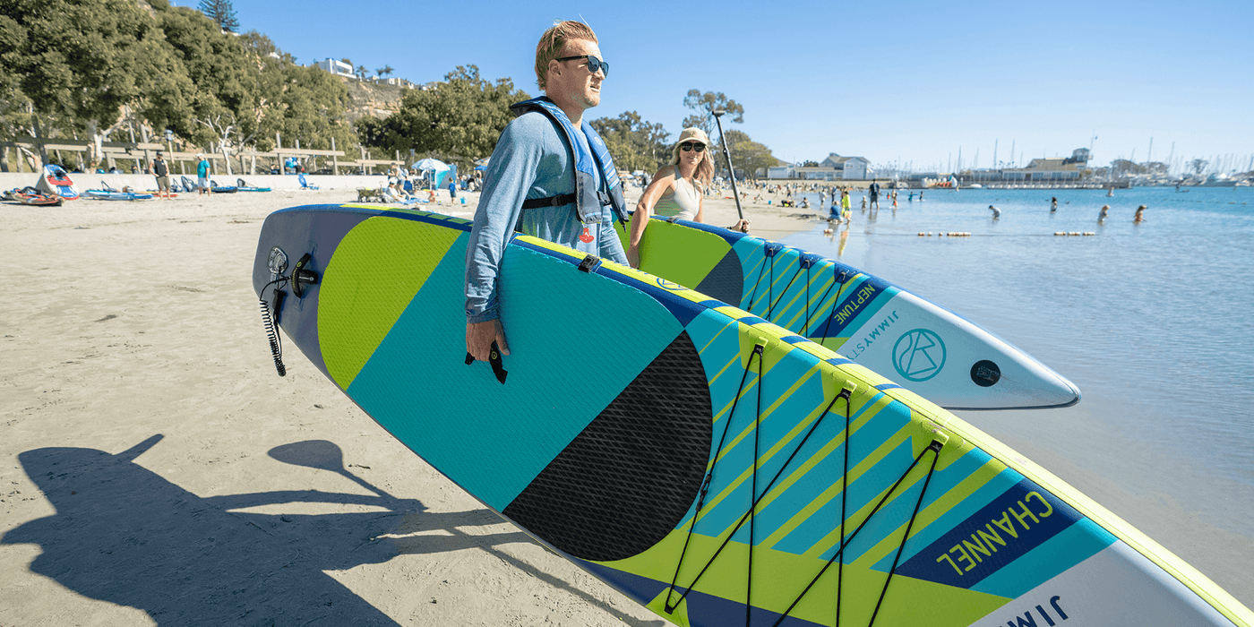 A man and a woman is about to paddling with jimmy Styks Inflatable SUPs