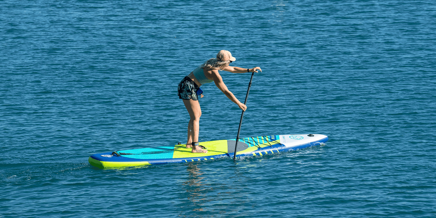A woman is paddling with ISUPs