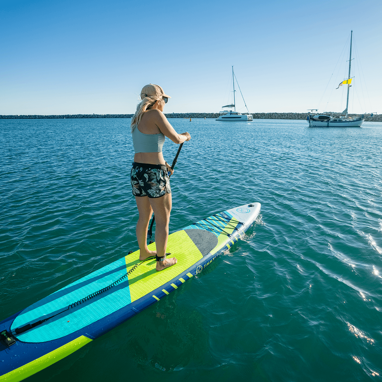 A woman is paddling with Jimmy Styks Inflatable SUP