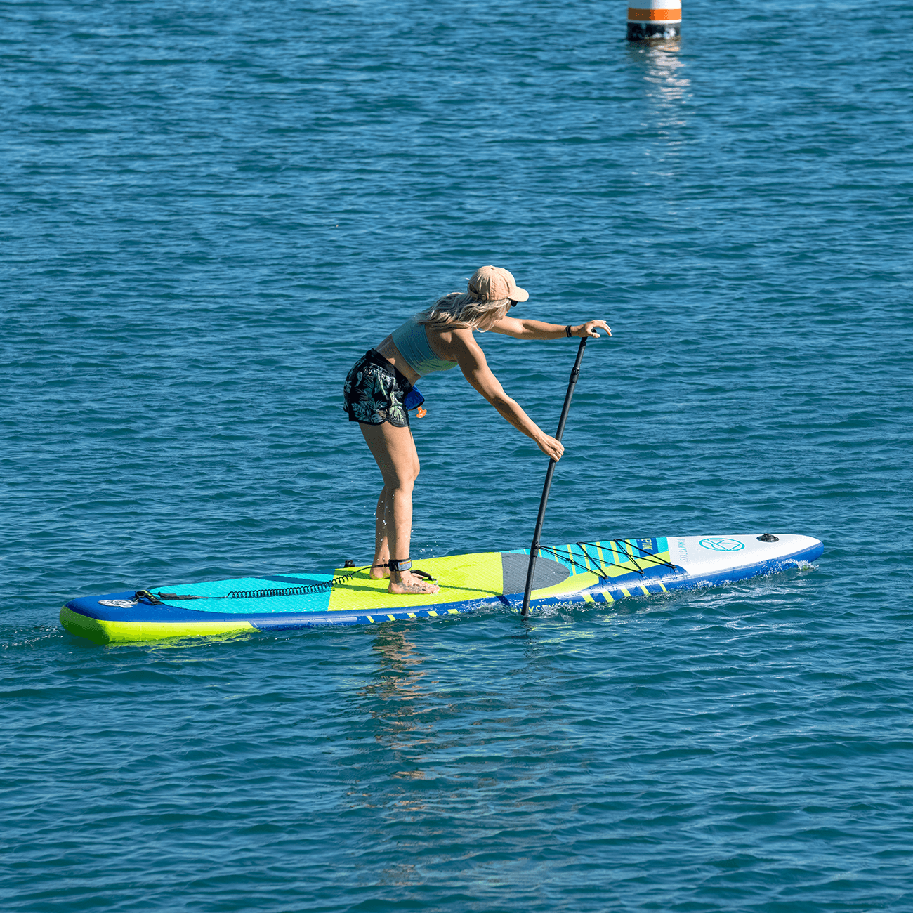 A woman is paddling with ISUPs