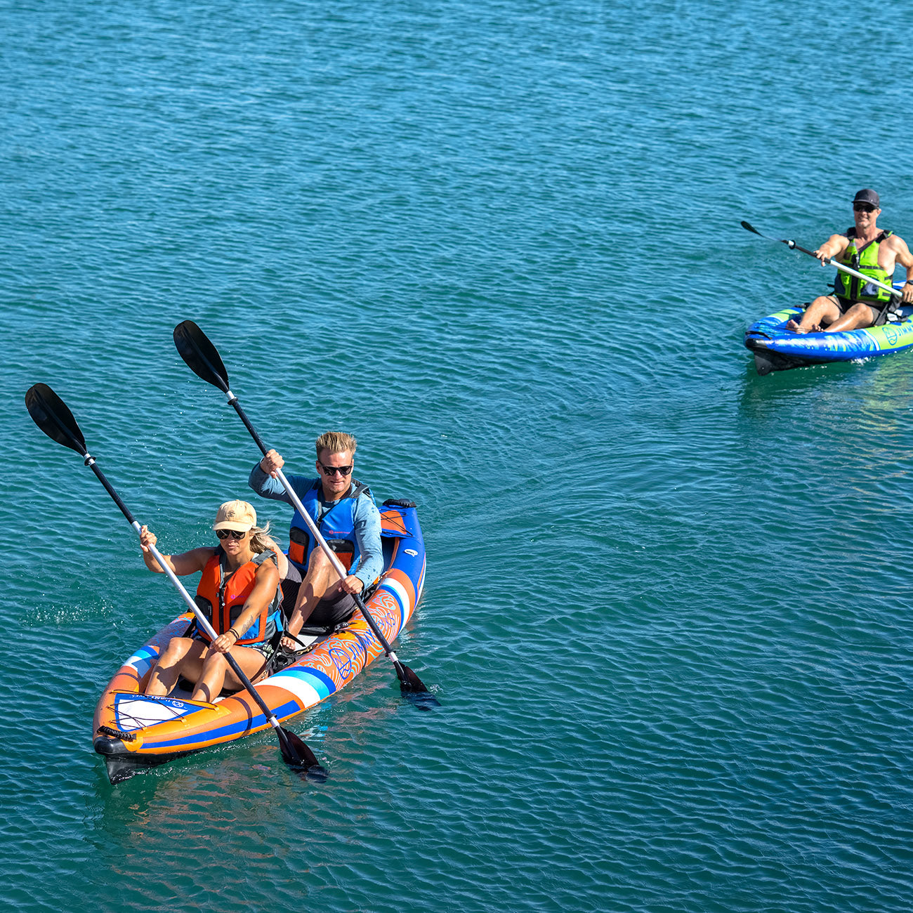 A pair of couple is paddling with inflatable kayak