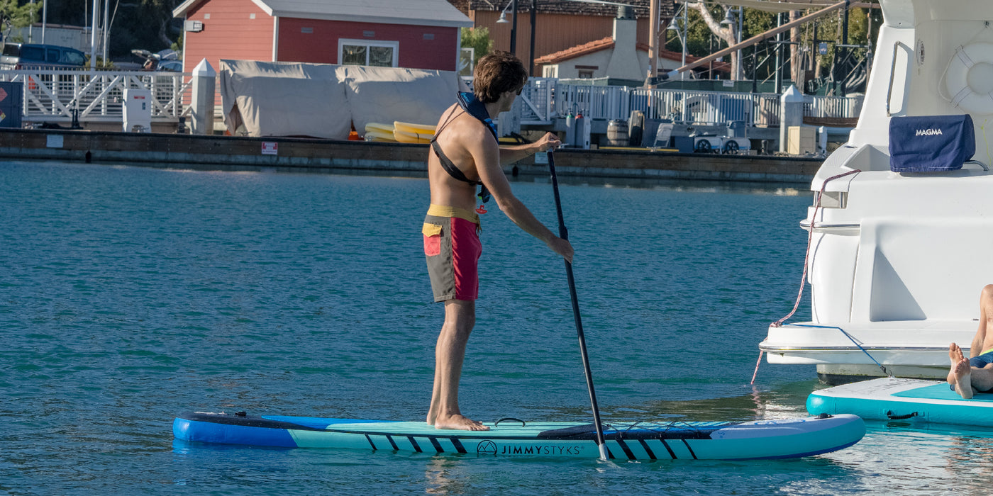 A boy is paddling with Inflatable SUPs